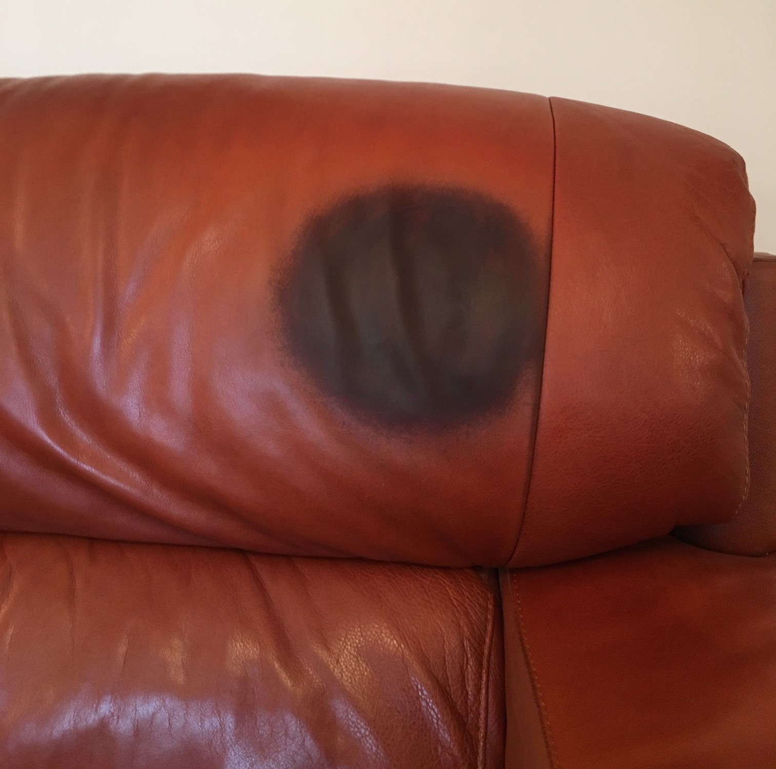 Removing Greasy stains from leather head rest